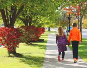 Two children walk down Broadway Street in Downtown Mt. Pleasant, Michigan, enjoying the fall colors.