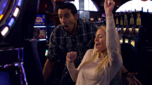 A man and a woman celebrating a win on a slot machine inside Soaring Eagle Casino in Mt. Pleasant, Michigan.