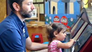 A father and young daughter, age three, sit at a painting station at the Mt. Pleasant Discovery Museum, a children's museum made up of Michigan-made exhibits for experimenting, discovering and exploring science and education in a fun way.
