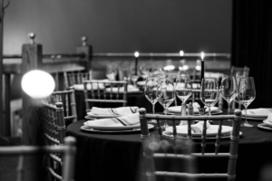 Beautiful black and white photo of dinner set up inside the Brass Cafe in Downtown Mt. Pleasant.