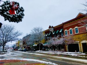 A snow-covered downtown Mt. Pleasant, Michigan, featuring the north-side businesses on Broadway Street.