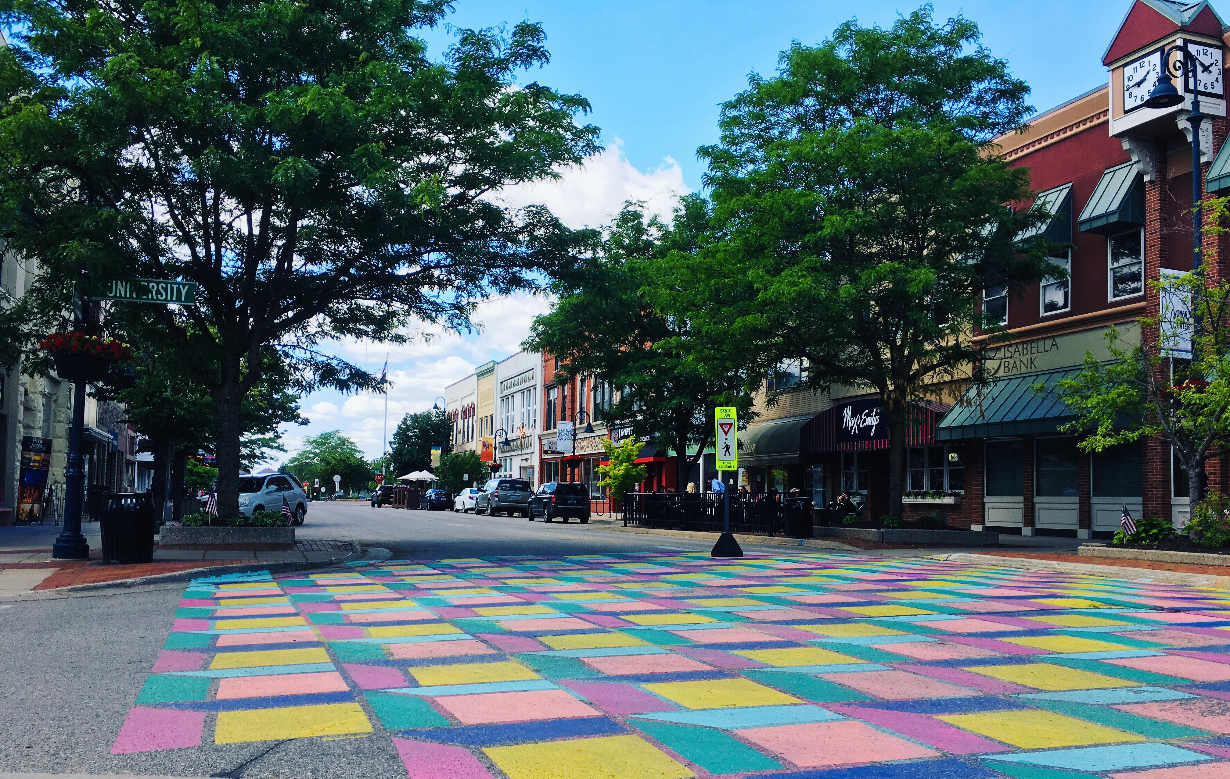 Downtown Mt. Pleasant, Michigan storefronts including Max and Emily's Eatery, Art Reach of Mid-Michigan and more during the summer.