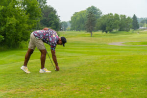 A golfer setting up his tee at Riverwood.