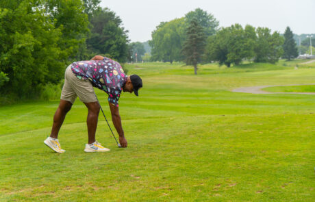 A golfer setting up his tee at Riverwood.