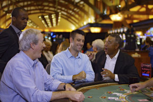 Men playing a table game at Soaring Eagle Casino.