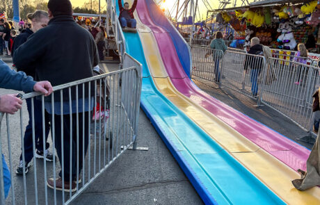 A kid going down the slide at the Shepherd Maple Syrup Festival Fair.