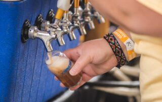 A person pouring beer at the festival.