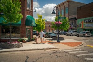 Couple walking on sidewalk in downtown Mt. Pleasant